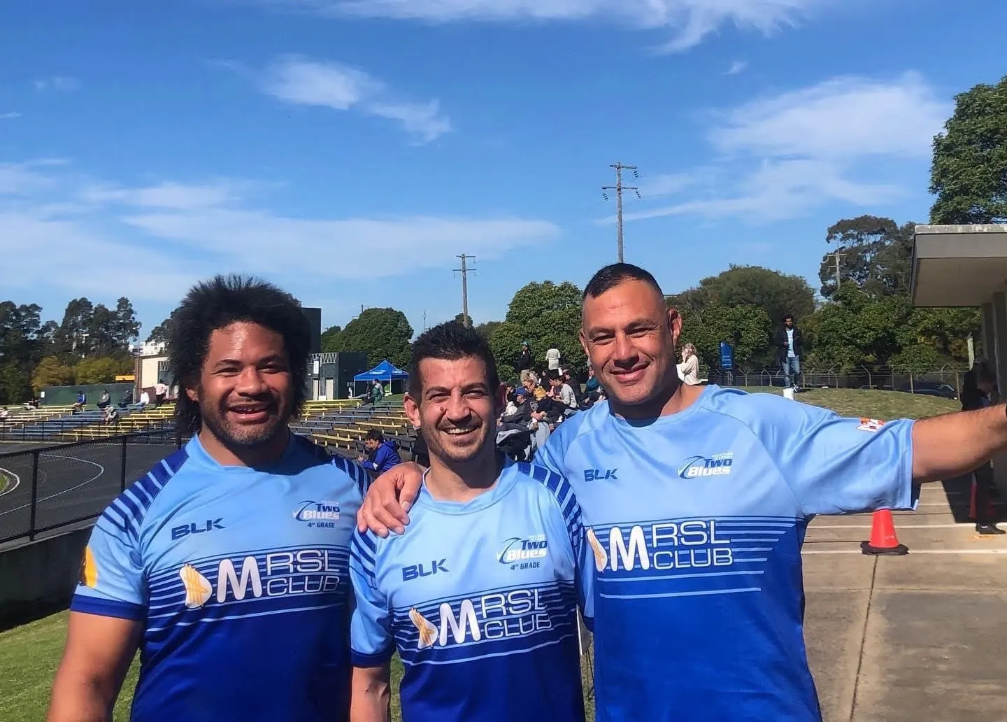 Tatafu Polota-Nau and Rodney Taylor pose with a teammate in light-blue club jerseys.