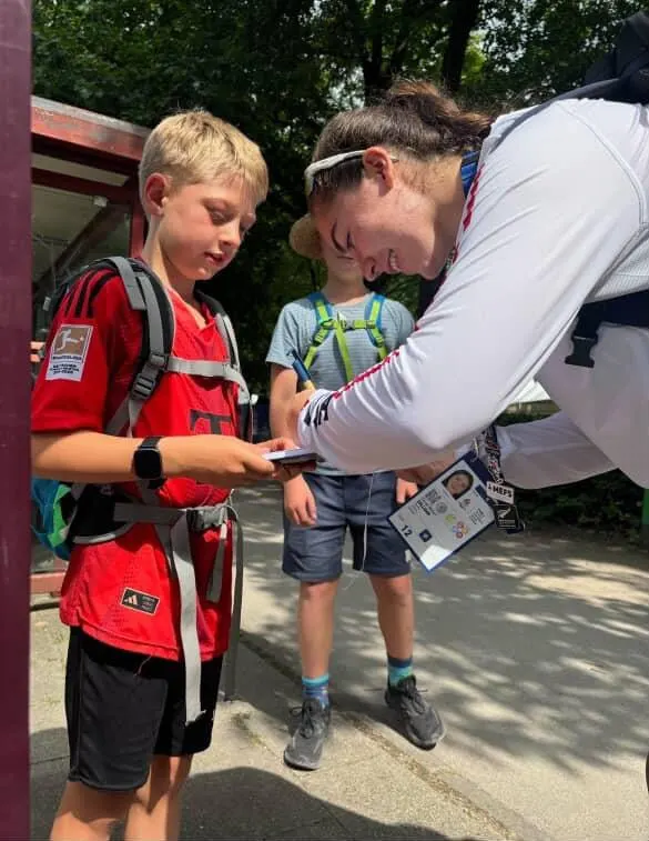 Midori Galligan signs an autograph for two young fans.